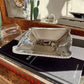 Silver dish on top of a book with a blurred indoor background