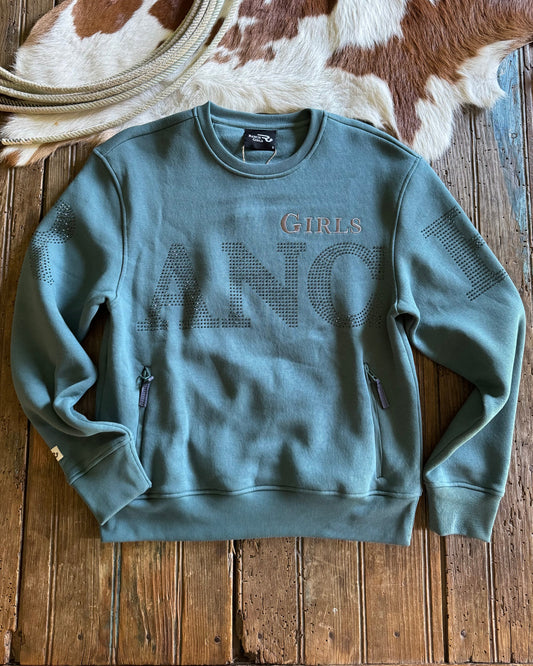 blue sweatshirt with 'RANCH GIRLS' text on a wooden surface with cowhide rug