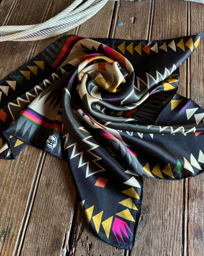 Colorful patterned scarf on a wooden surface