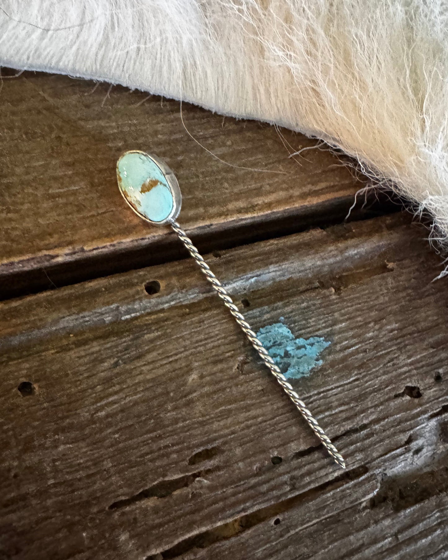 Gold necklace with a pendant on a wooden surface