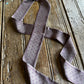 Purple patterned tie on a wooden surface