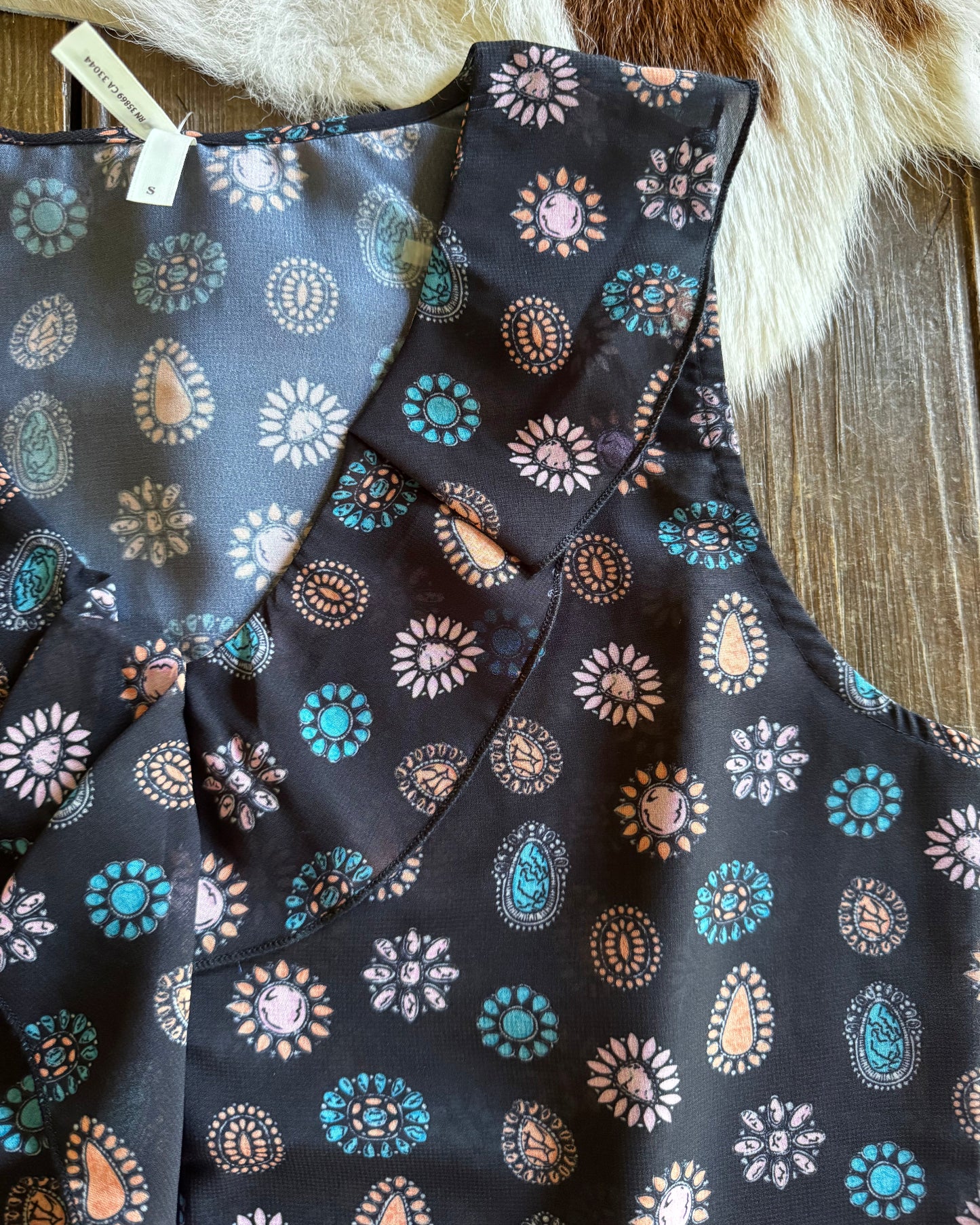 Folded fabric with floral pattern on a wooden surface