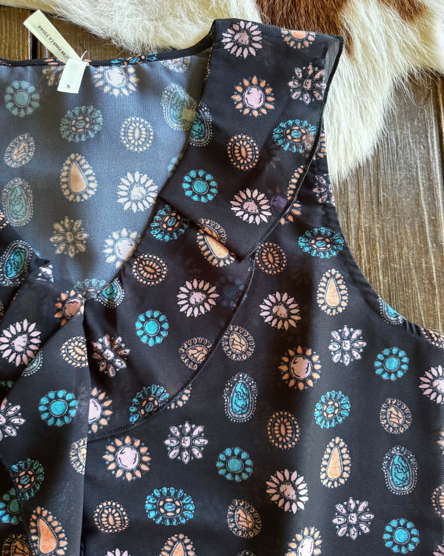 Folded fabric with floral pattern on a wooden surface