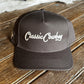 Dark gray cap with 'Classic Cowboy' logo on a wooden surface