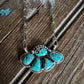Turquoise stone necklace on a wooden surface
