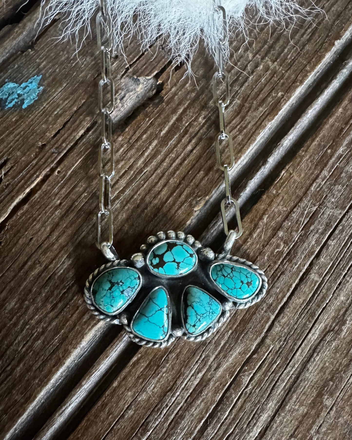 Turquoise stone necklace on a wooden surface