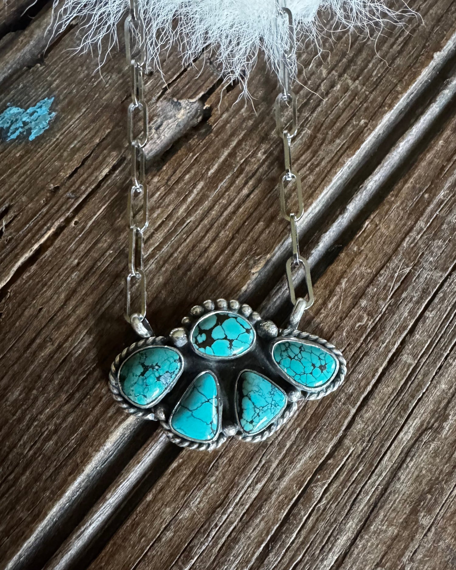 Turquoise stone necklace on a wooden surface