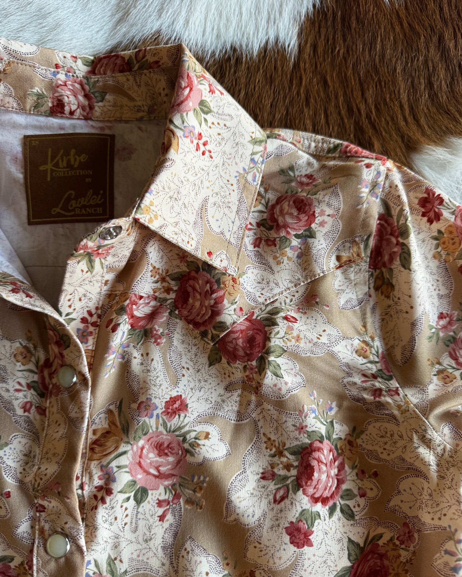 Floral patterned fabric with a brand tag on a textured surface