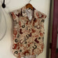 Sleeveless blouse hanging on a wall by a red door
