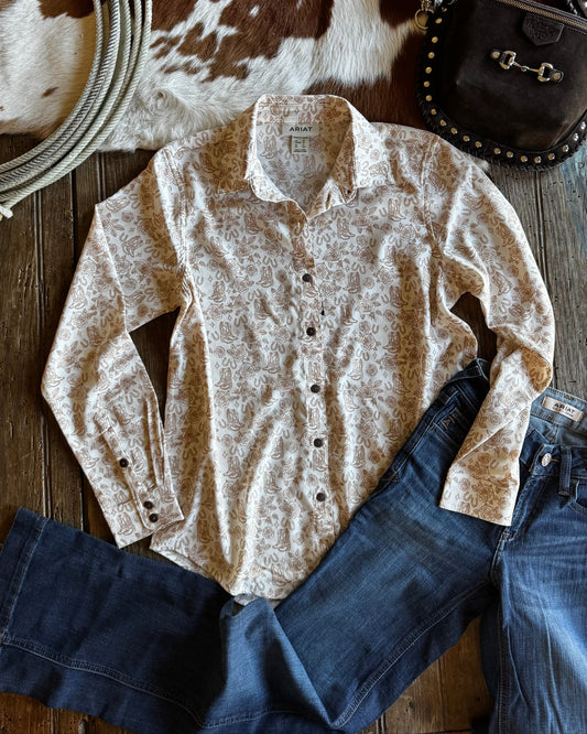 Button-up shirt, jeans, and a brown leather bag on a wooden surface with cowhide rug