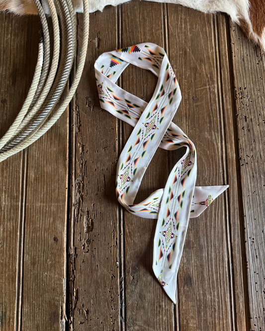 ribbon scarf with floral pattern on a wooden surface