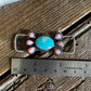 Turquoise and pink conch twilly slide on wooden background with ruler to show size
