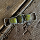 Twilly slide with three green stones on a wooden surface