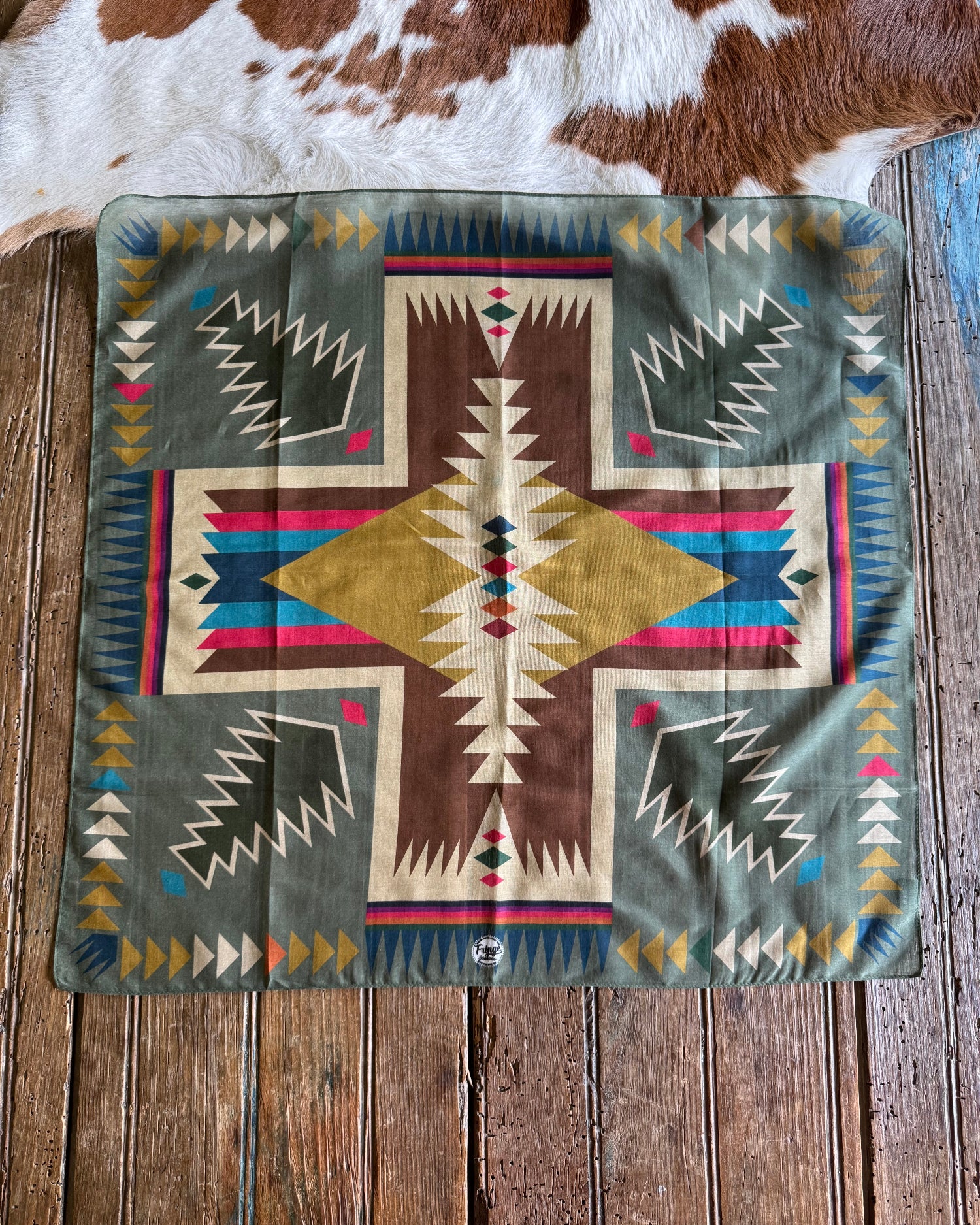 Decorative scarf with geometric pattern on a wooden surface
