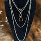 Holyoke Stirrup Necklace layered with other V2 necklaces