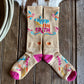 Colorful socks with text and designs on a wooden surface