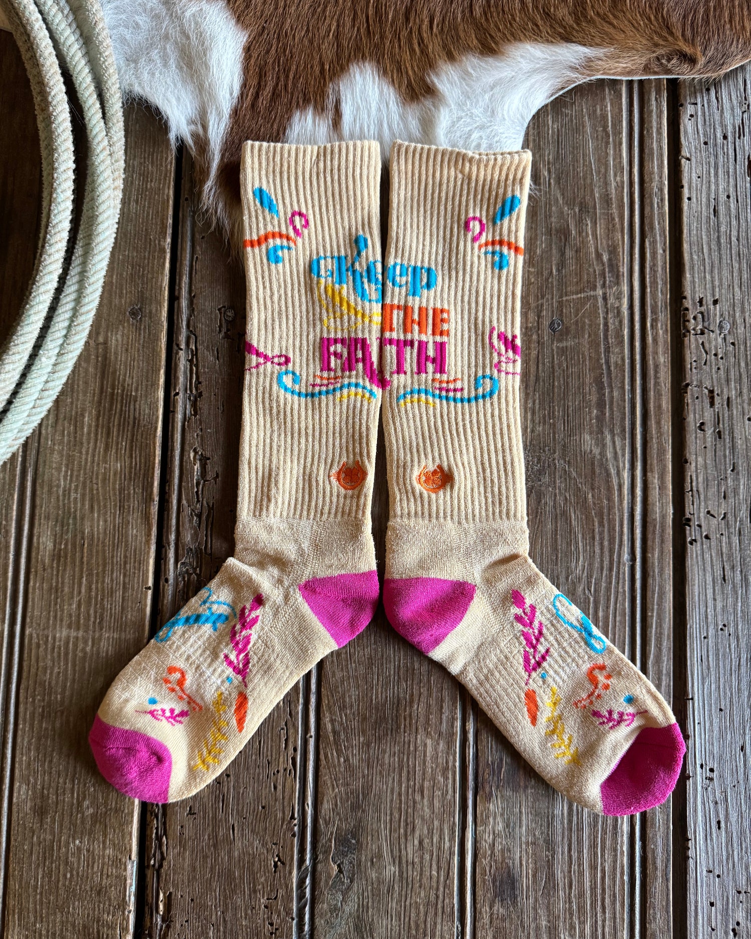 Colorful socks with text and designs on a wooden surface