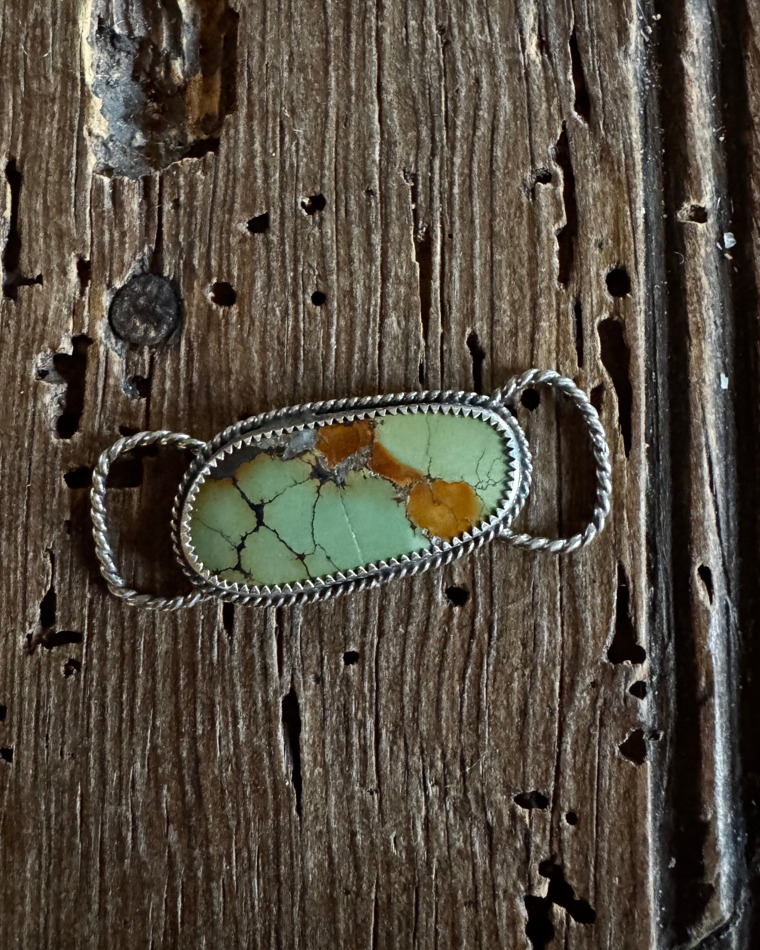 Hubei Turquoise twilly slide on a rustic wood background