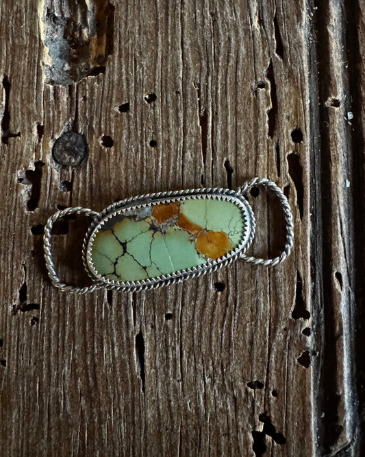 Hubei Turquoise twilly slide on a rustic wood background