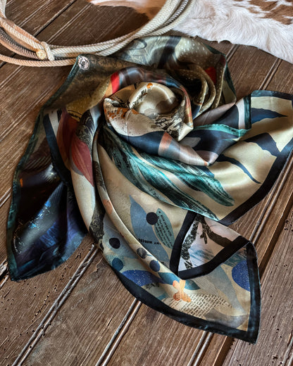 Colorful scarf with nature-themed design on a wooden surface