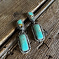 Turquoise earrings on a wooden surface