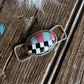 Decorative twilly slide with checkered design on a wooden surface