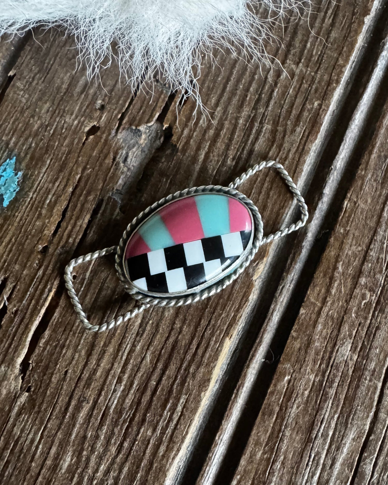 Decorative twilly slide with checkered design on a wooden surface