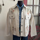 Beige embroidered jacket on a mannequin against a neutral background