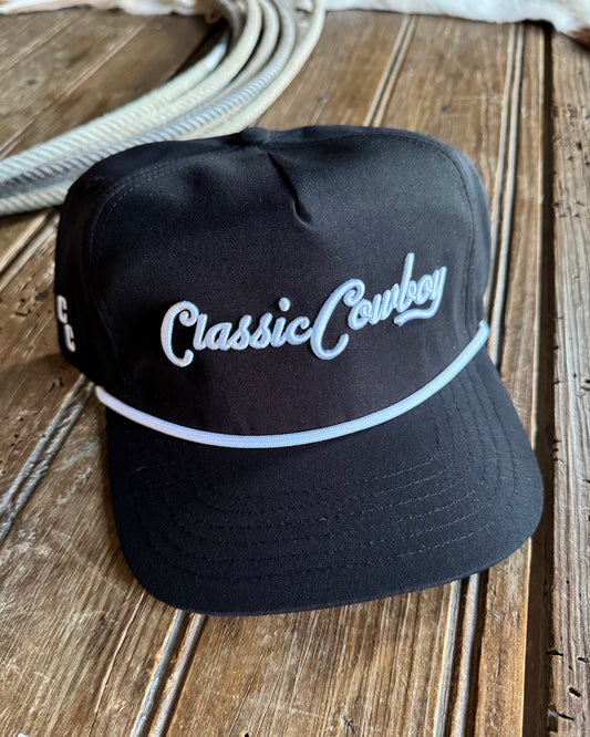 Black cap with 'Classic Cowboy' embroidery on a wooden surface