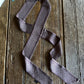 Purple patterned tie on a wooden surface