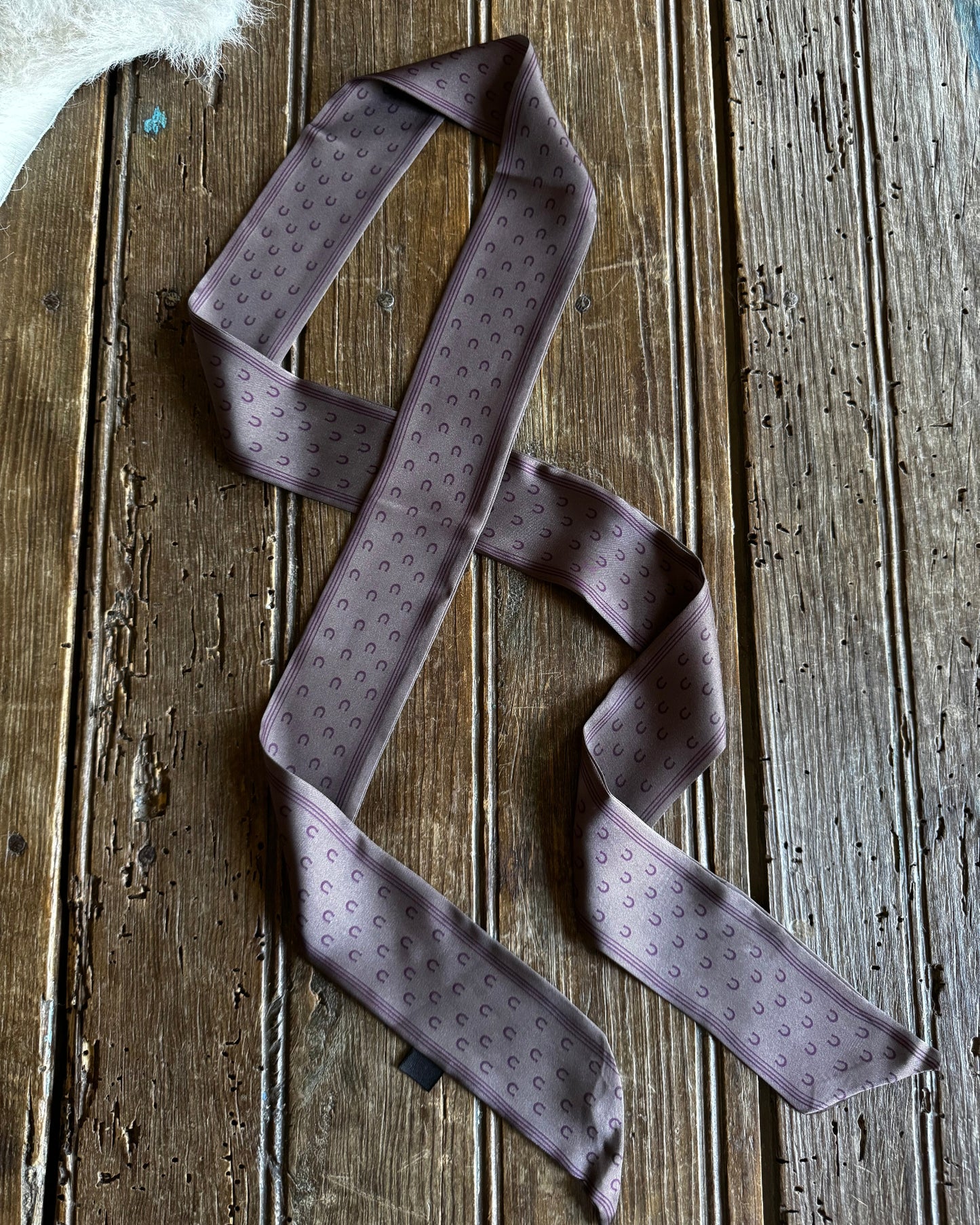 Purple patterned tie on a wooden surface