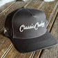Black cap with 'Classic Country' logo on a wooden surface