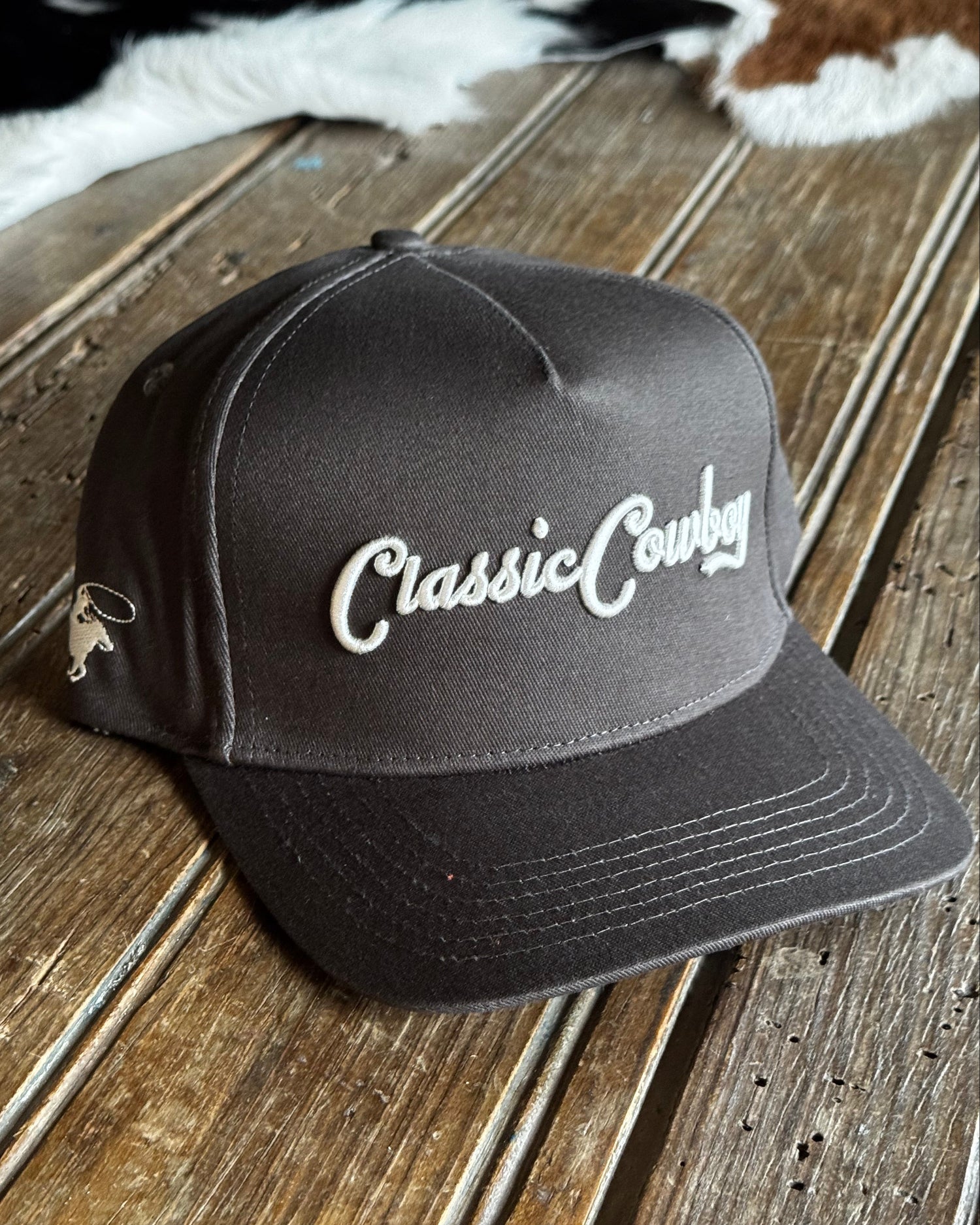 Black cap with 'Classic Country' logo on a wooden surface