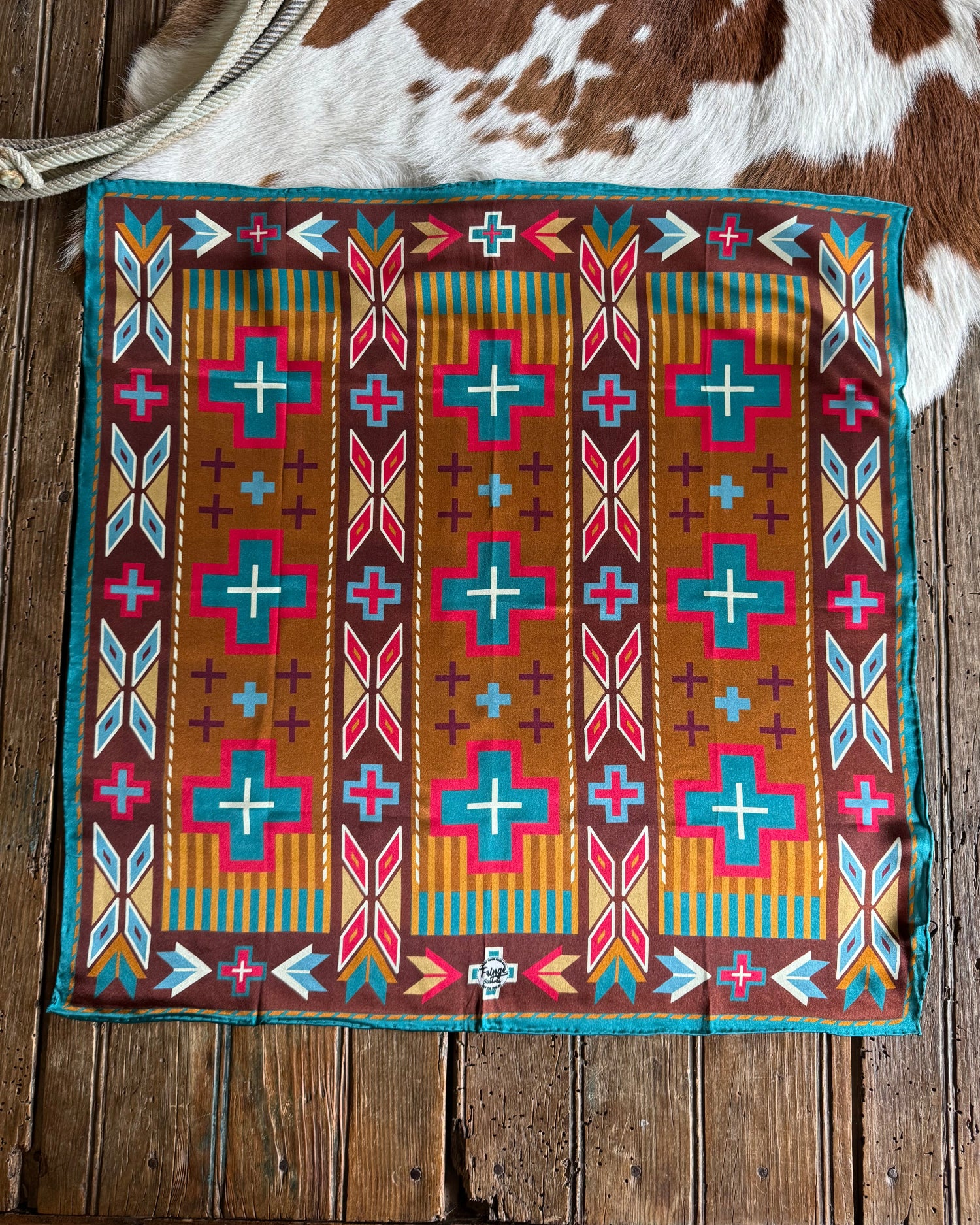 southwestern scarf on rustic wood and cowhide background