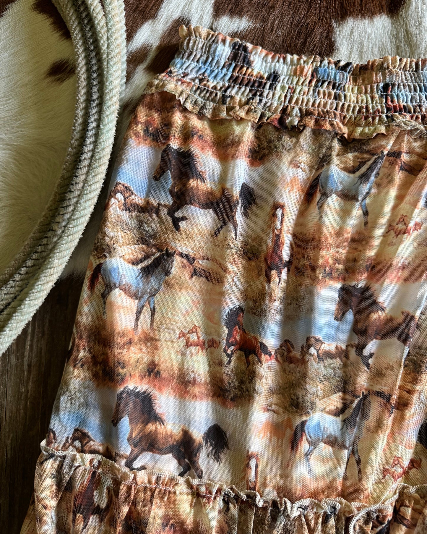 horse patterned skirt with ruffled edges on a textured surface