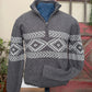 Gray sweater with a patterned design on a mannequin against a rustic background