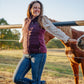 Woman standing next to a horse in an outdoor setting