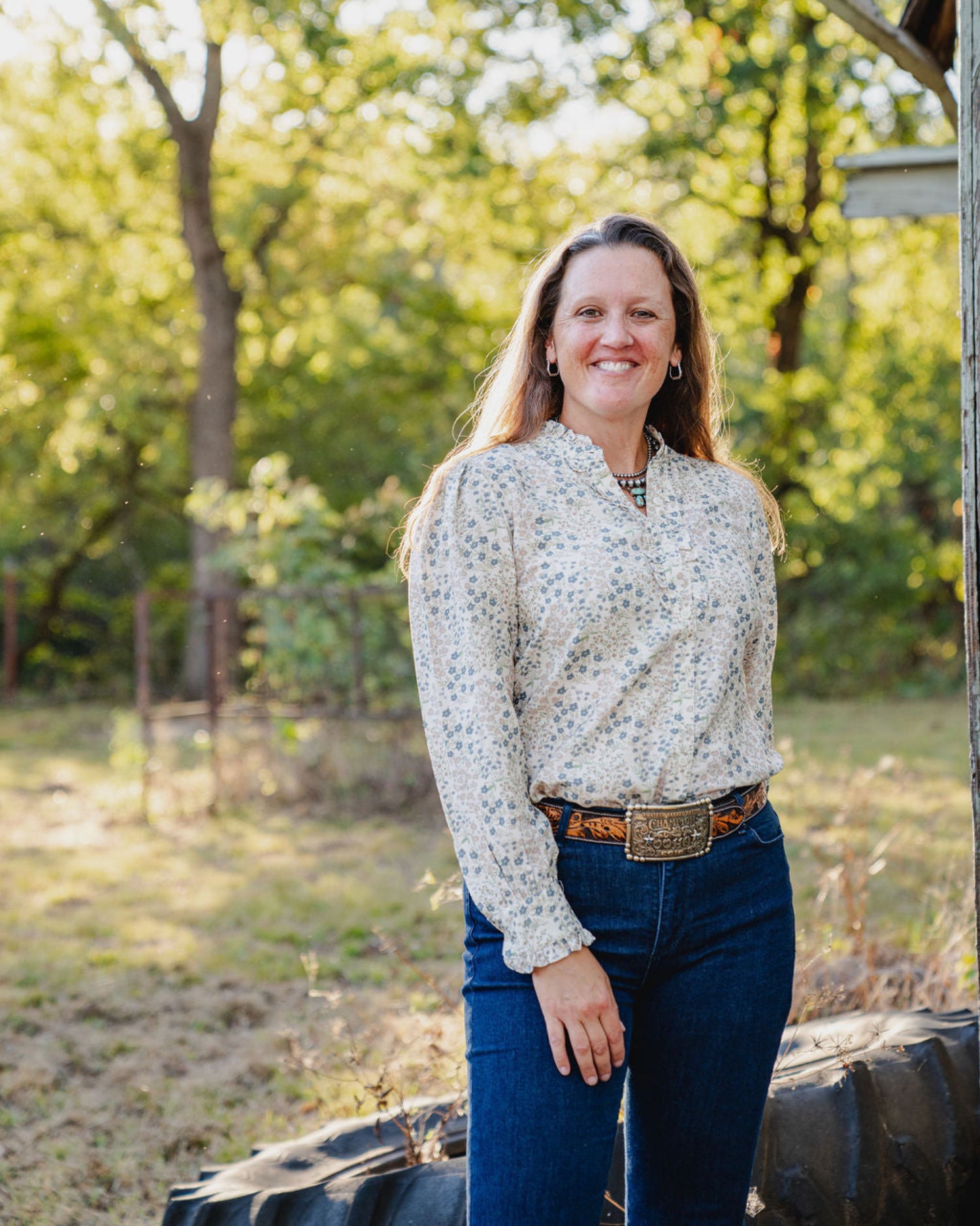 Woman standing outdoors with trees in the background