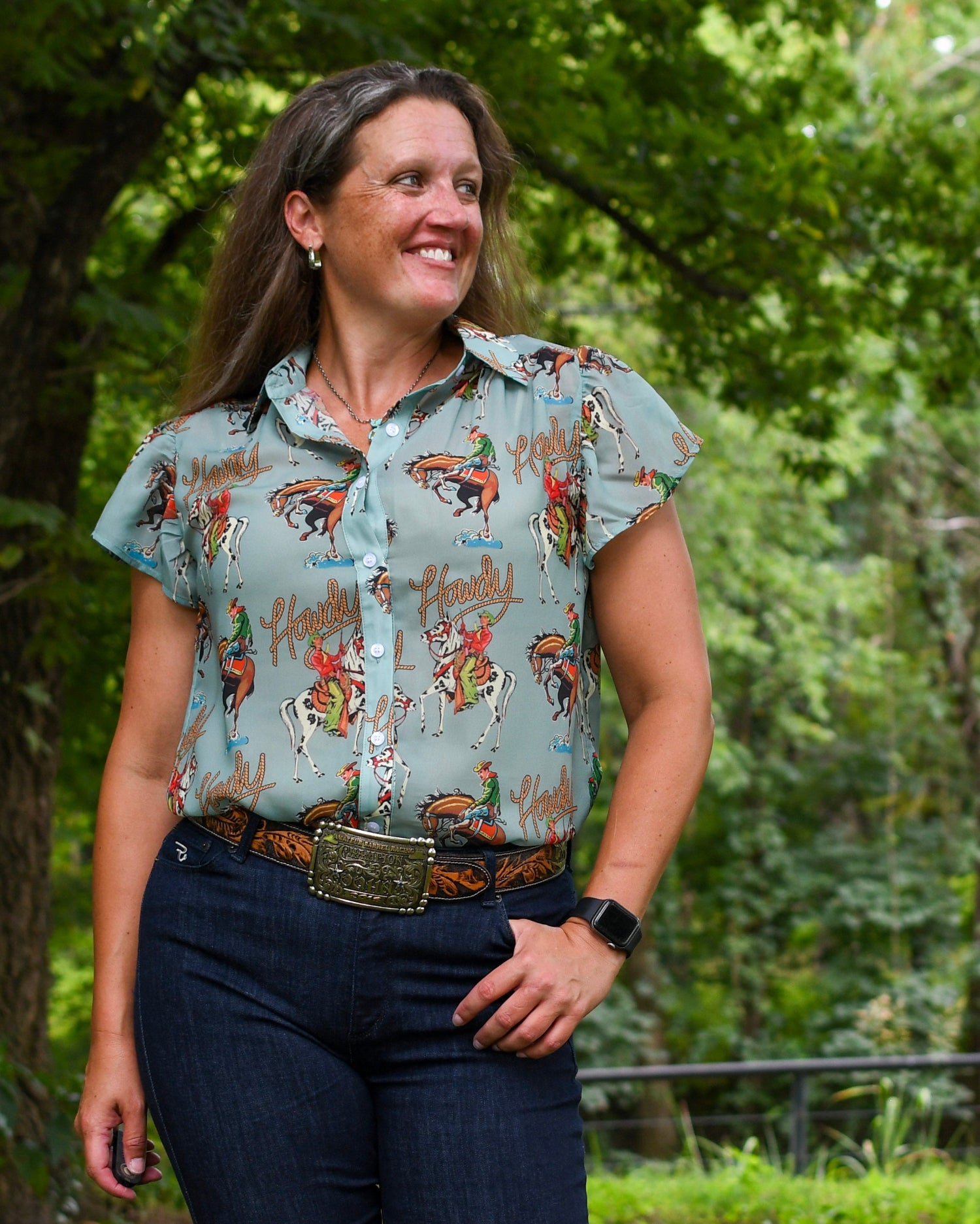 Woman wearing a patterned shirt with nature in the background