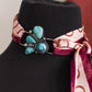 scarf with a decorative brooch and patterned scarf on a neutral background