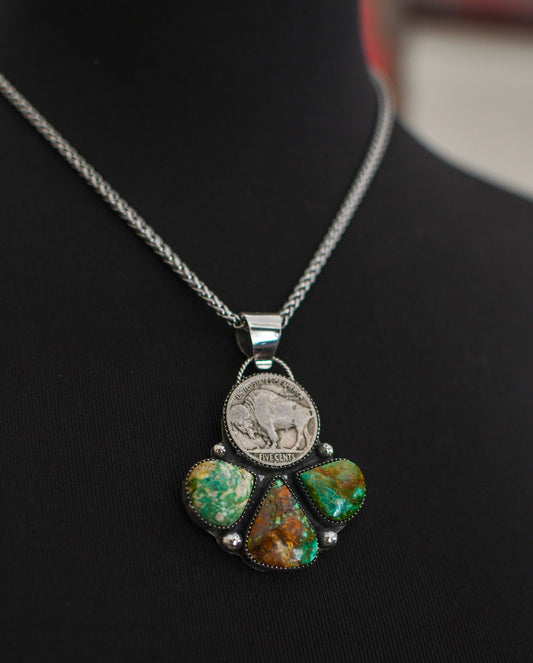 Buffalo Nickel and turquoise pendant on black mannequin 