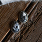 White buffalo earrings on a rustic wooden background