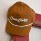 Baseball cap hanging on a door with a white background