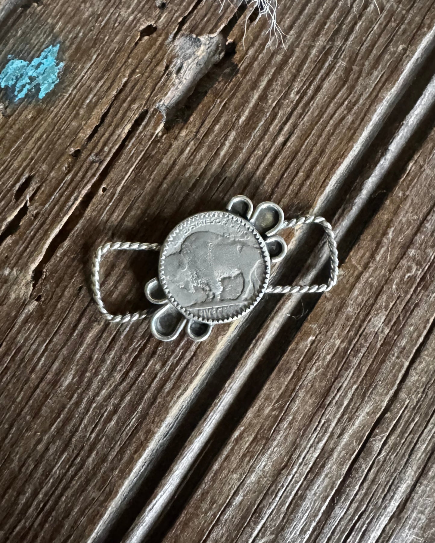 Silver necklace with pendant on a wooden surface