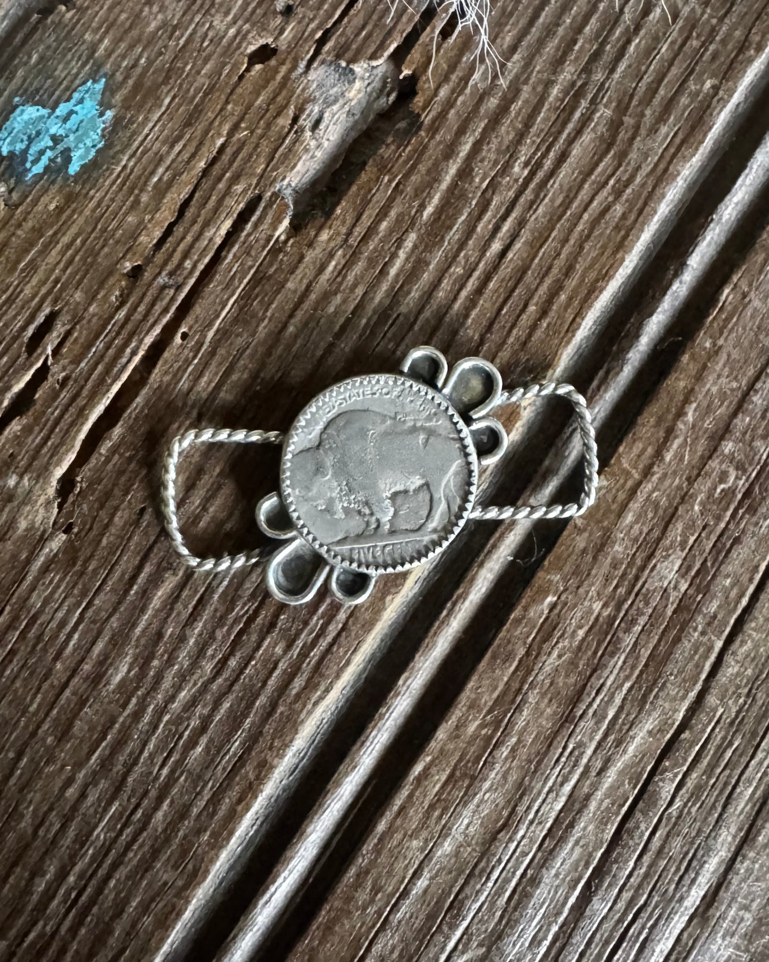 Silver necklace with pendant on a wooden surface
