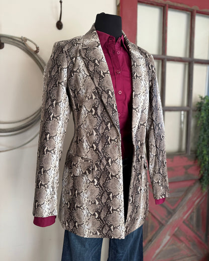 Snakeskin-patterned jacket on a mannequin against a neutral background