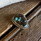 scarf slide with turquoise stone on a wooden surface
