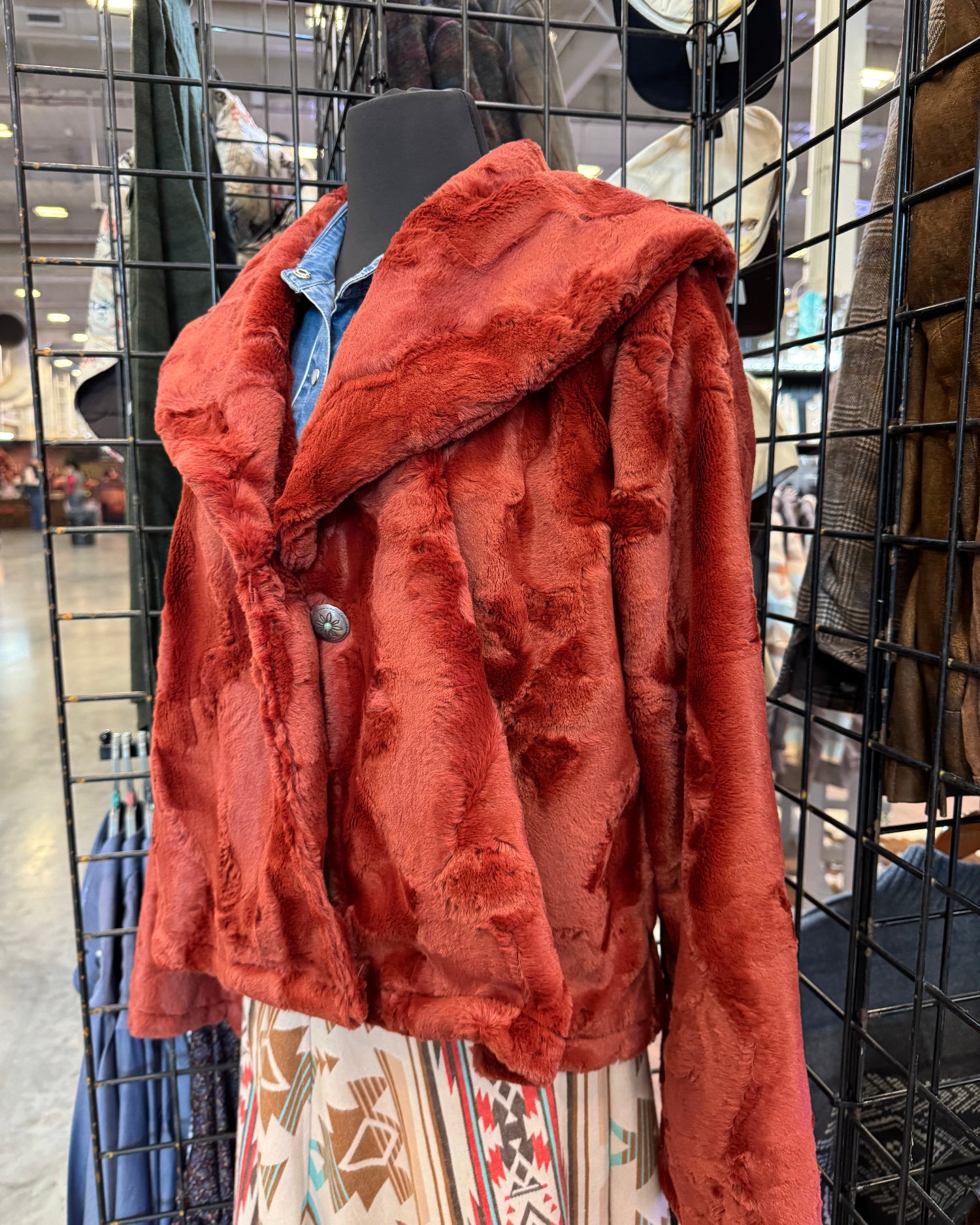 Red jacket on a rack with a patterned fabric background