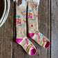 Colorful socks with text and patterns on a wooden surface