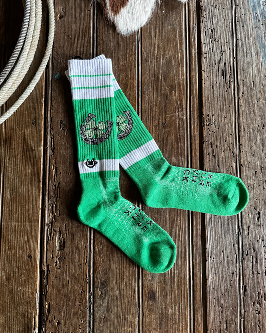 Green socks with a logo on a wooden surface